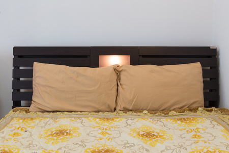 Bed in a hotel room , Thailand.の写真素材