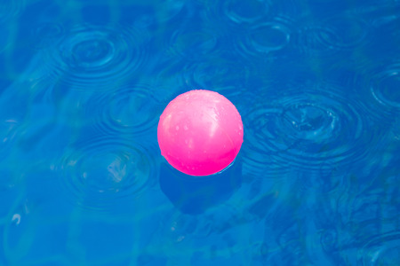 Pink plastic ball in pool , pool villa house.の写真素材