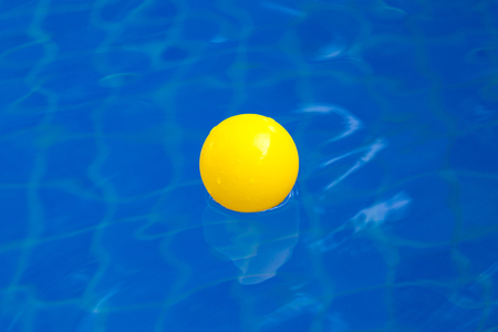 Yellow plastic ball in pool , pool villa house.の写真素材