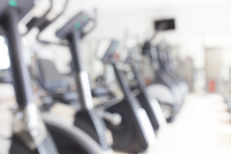 Abstract blur fitness gym with equipment for background.