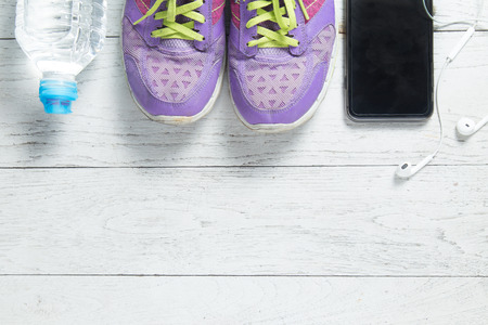 Sport flat lay purple shoes, smartphone and workout equipments on white wooden background with copyspace for your text. Concept healthy lifestyle and diet.の写真素材