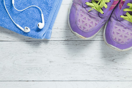 Sport flat lay purple shoes and workout equipments on white wooden background with copyspace for your text. Concept healthy lifestyle and diet.の写真素材