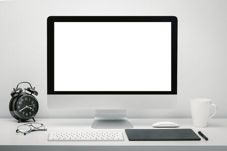 Stylish workspace with blank screen computer display for mockup on work desk with keyboard, mouse,...