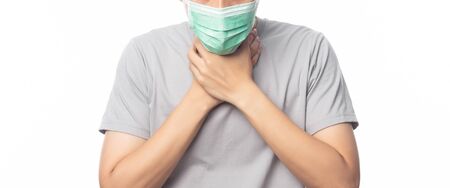 Closeup Young Man in hygienic mask suffering sore throat, 2019-nCoV or coronavirus. Airborne respiratory illness such as pm 2.5 fighting and flu isolated on white background. Banner size.の写真素材