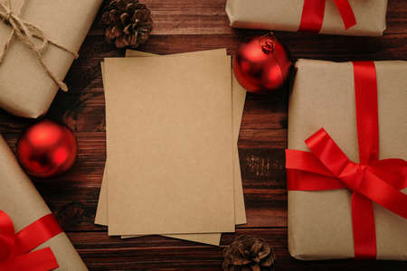 Christmas and new year with gift boxes and string light decoration on wooden table background top...