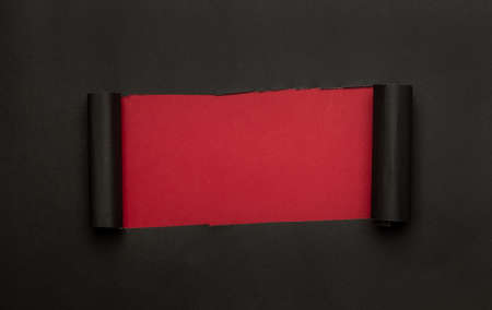 Black torn paper on red background. Black Friday campaign.