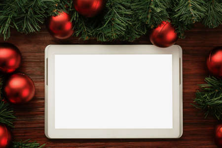 Merry christmas tablet computer mockup template with pine leaves decorations.の写真素材