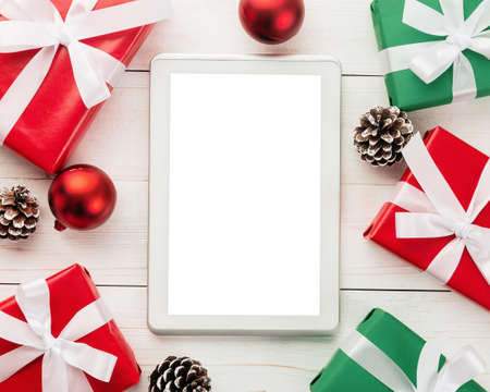 Merry christmas tablet computer mockup template with pine leaves decorations.