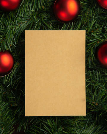 Merry christmas paper note mockup template with pine leaves decorations.