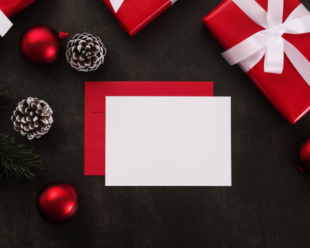 Blank white greeting card and envelope mockup with christmas gifts decorations on grunge background.の写真素材