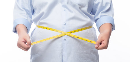 Fat man holding a measurement tape for check out his body isolated on white background.
