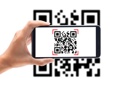 Hand using mobile smart phone scan Qr code on white background. Cashless technology and digital money concept.の写真素材
