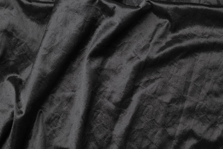 Abstract black fabric cloth texture background or liquid wave or wavy folds.