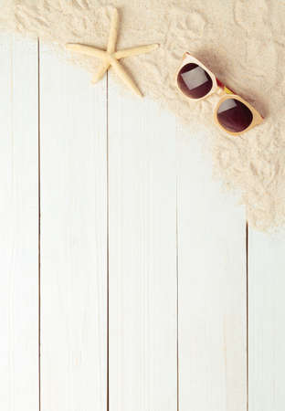 Summer background with beach accessories - sunglasses on white wood table background top view with copy space.の写真素材