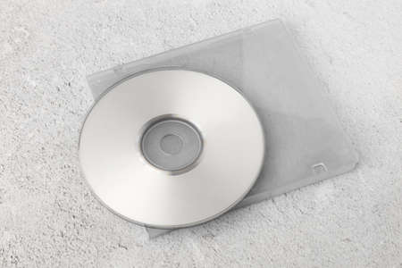 Realistic white cd template with box cover on white cement background.