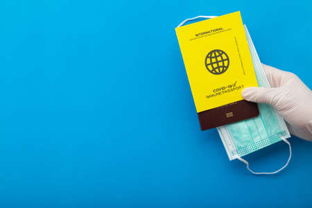 Hand holding vaccine passports as proof that the holder has been vaccinated  , Requirement for international travel.の写真素材