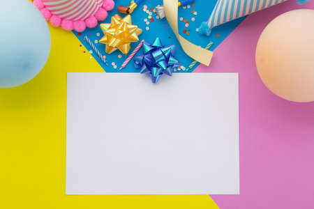 Happy birthday background, Flat lay colorful party decoration with flyer invitation card on pastel yellow, blue and pink geometric background.の写真素材