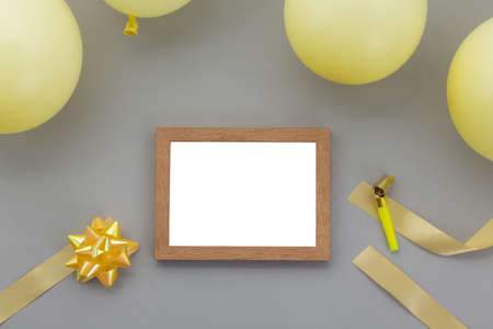 Happy birthday background, Flat lay party decoration with photo frame on pastel grey background.