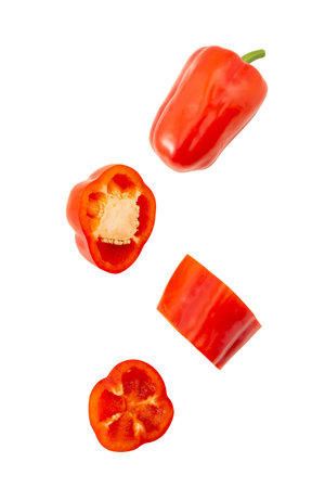 Falling Red bell pepper slice isolated on white background with clipping path.の写真素材