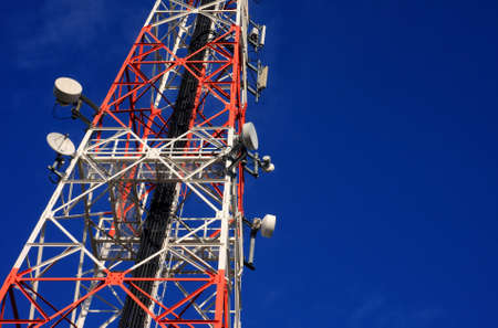 communications tower and satellite on blue sky