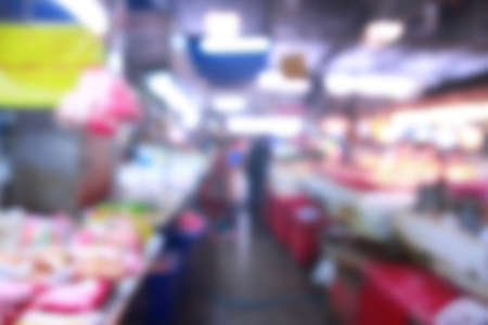 Blurred background of generic supermarket people walking shoppingの写真素材