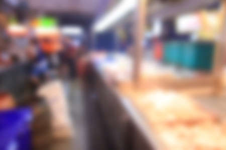 Blurred background of generic supermarket people walking shoppingの写真素材
