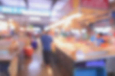 Blurred background of generic supermarket people walking shoppingの写真素材