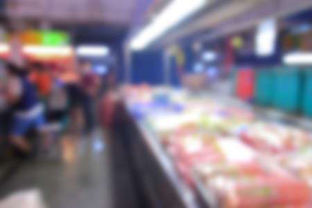 Blurred background of generic supermarket people walking shoppingの写真素材
