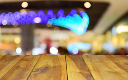 blurred image wood table and abstract department store shopping mall center and people backgroundの写真素材
