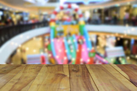blurred image wood table and abstract department store shopping mall center and people background