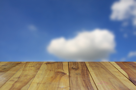 blurred image wood table and abstract blue sky backgroundの写真素材