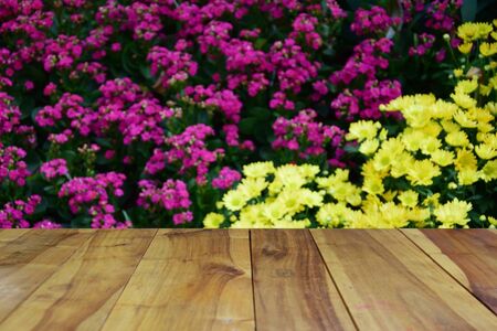blurred image wood table and abstract background of flowersの写真素材