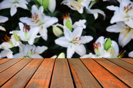 blurred image wood table and abstract background of flowersの写真素材