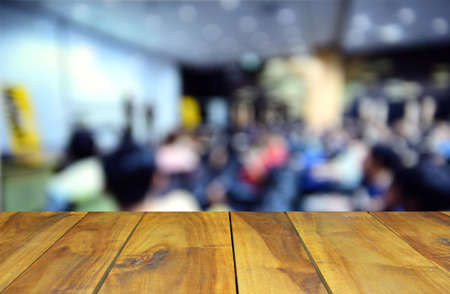 blurred image wood table and abstract Conference and Presentation. Audience at the conference hallの写真素材