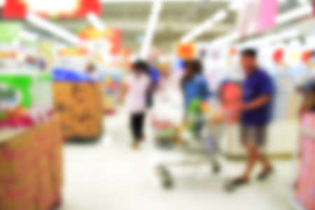 Blurred background of generic supermarket people walking shoppingの写真素材