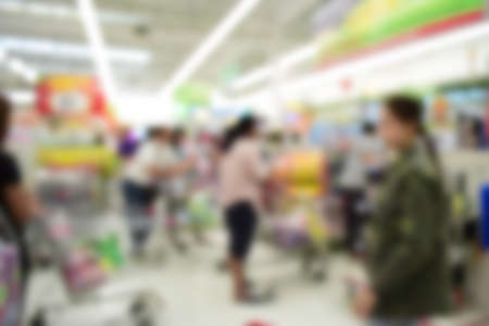 Blurred background of generic supermarket people walking shoppingの写真素材