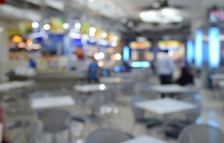blurred photo of people in food center with light bokehの写真素材