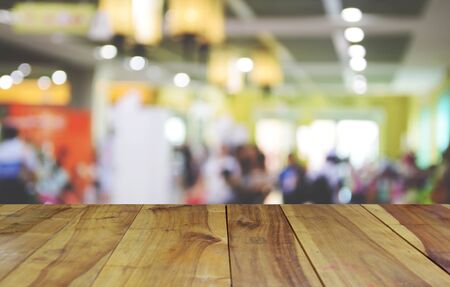 blurred image wood table and abstract trade show and one stop shopping expoの写真素材