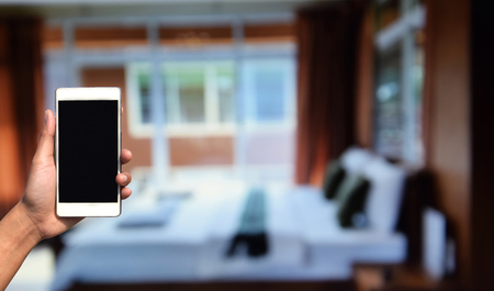 blurred photo and smartphone on bed room decorationの写真素材