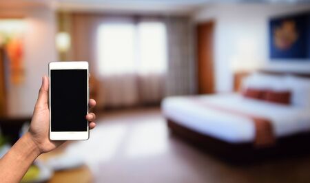 blurred photo and smartphone on bed room decoration