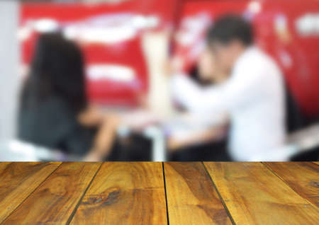 blurred image wood table and Businessmen and women in work conference