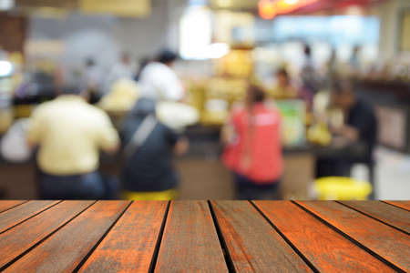 blurred image wood table and food center at shopping mall and people with bokehの写真素材