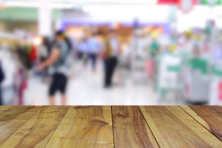 blurred image wood table on shopping mall backgroundの写真素材