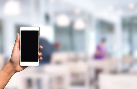 blurred photo and smartphone on shopping mall centerの写真素材