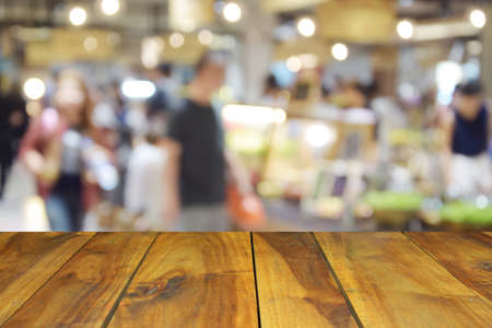 blurred image wood table on food center at shopping mall and people with bokehの写真素材