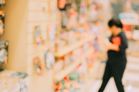 Blurred image abstract people and bookshelves in library as backgroundの写真素材