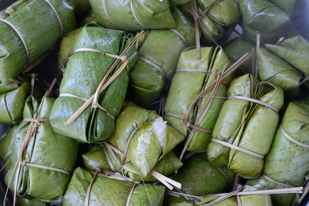 closeup of glutinous rice steamed in banana leaf in steam pot ; selective focus with blur backgroundの写真素材