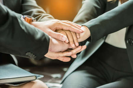 Business people joining hands together,group of business people with hands together.Teamwork...