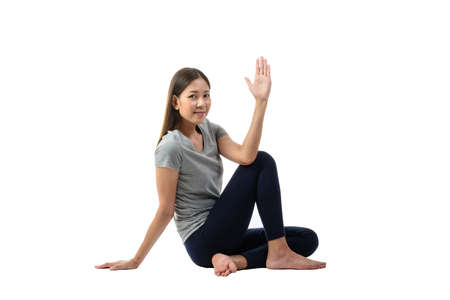 Young asian smiling woman practicing yoga, sitting in easy pose , healthy woman. Concept of healthy lifestyle and relaxation. Portrait isolated,studio shot.の写真素材