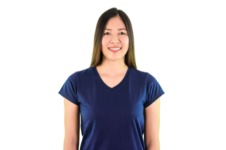 Asian young woman in blue shirt smiling and looking at the camera on white background.の写真素材